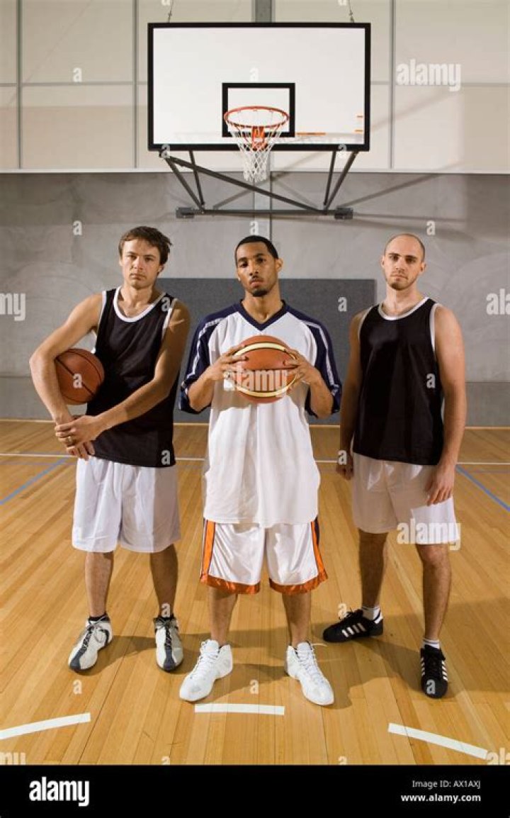 three basketball players standing next to each other in front of a